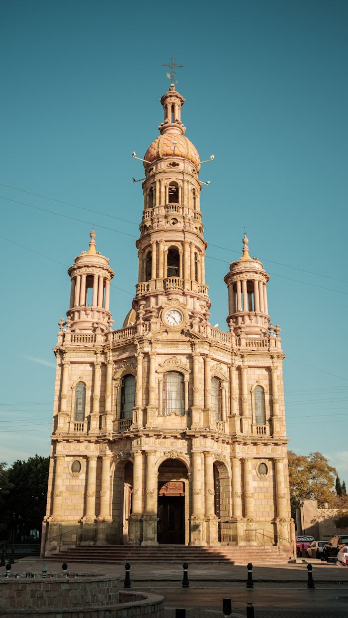 Sunlit Baroque church facade in Aguascalientes, Mexico, showcasing stunning sacral architecture.